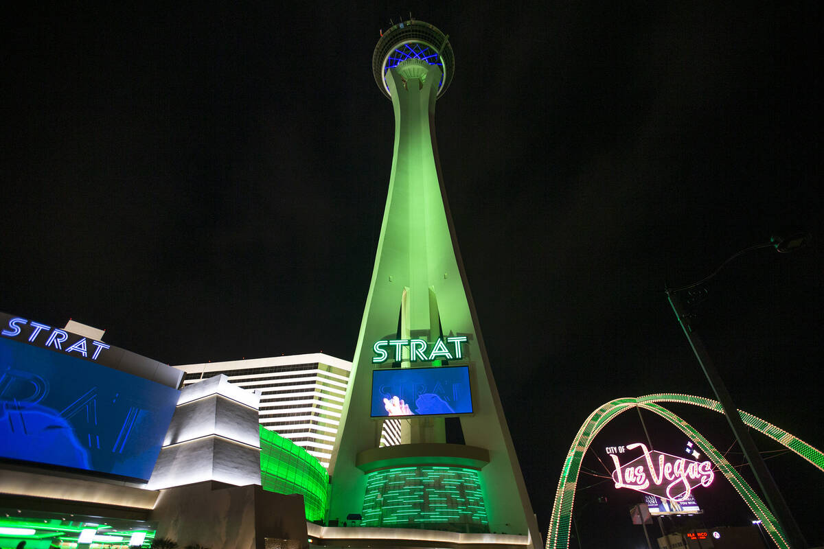 The Strat and the Las Vegas Boulevard Gateway Arches are lit green for St. Patrick's Day on Wed ...