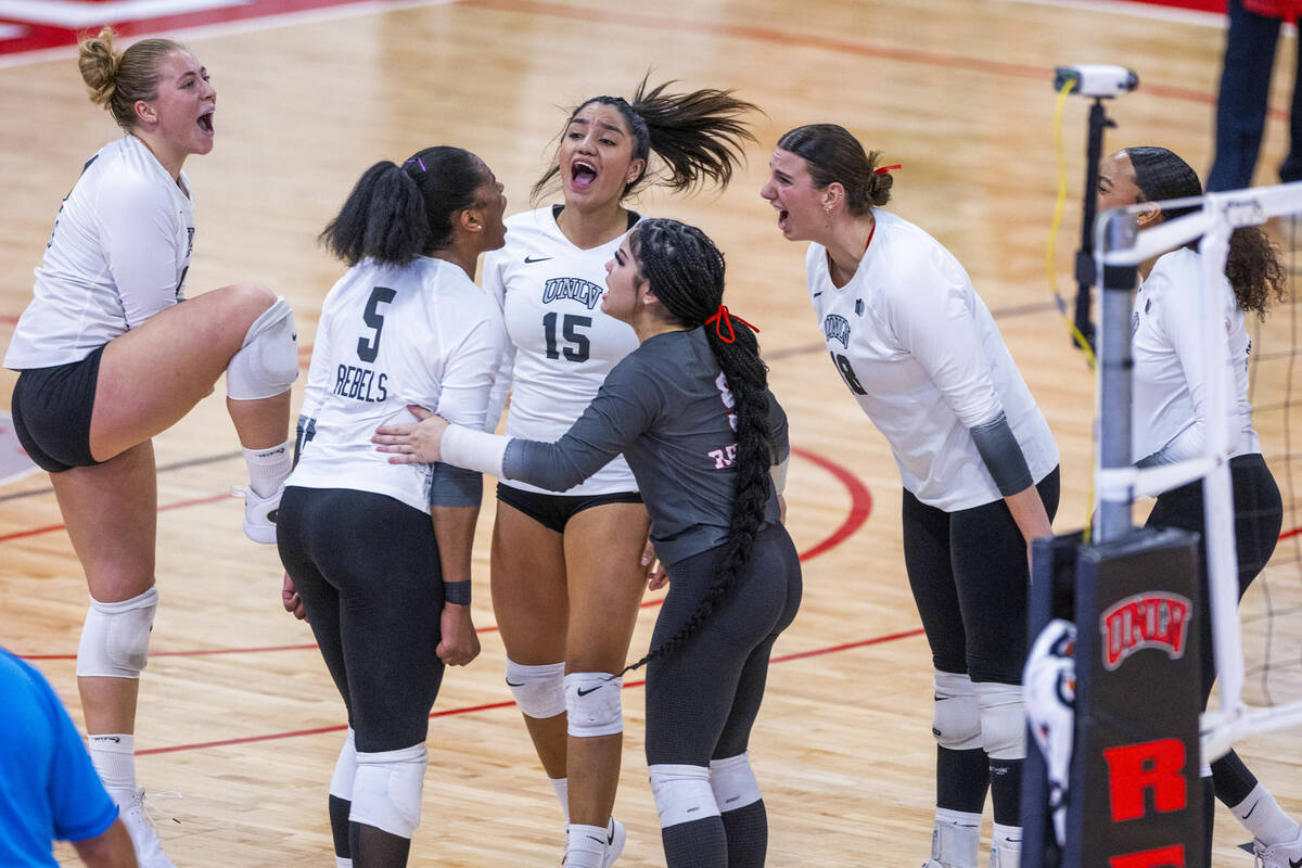 UNLV players celebrate a critical point as they take the first set against San Jose State durin ...