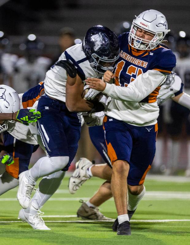 Shadow fullback Ridge Aaron Smith (31) battles for more yards as Legacy kicker Angel Alba (13) ...