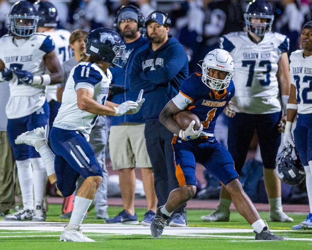 Legacy wide receiver Dominic Oliver (1) attempts to maneuver past Shadow Ridge cornerback Josep ...