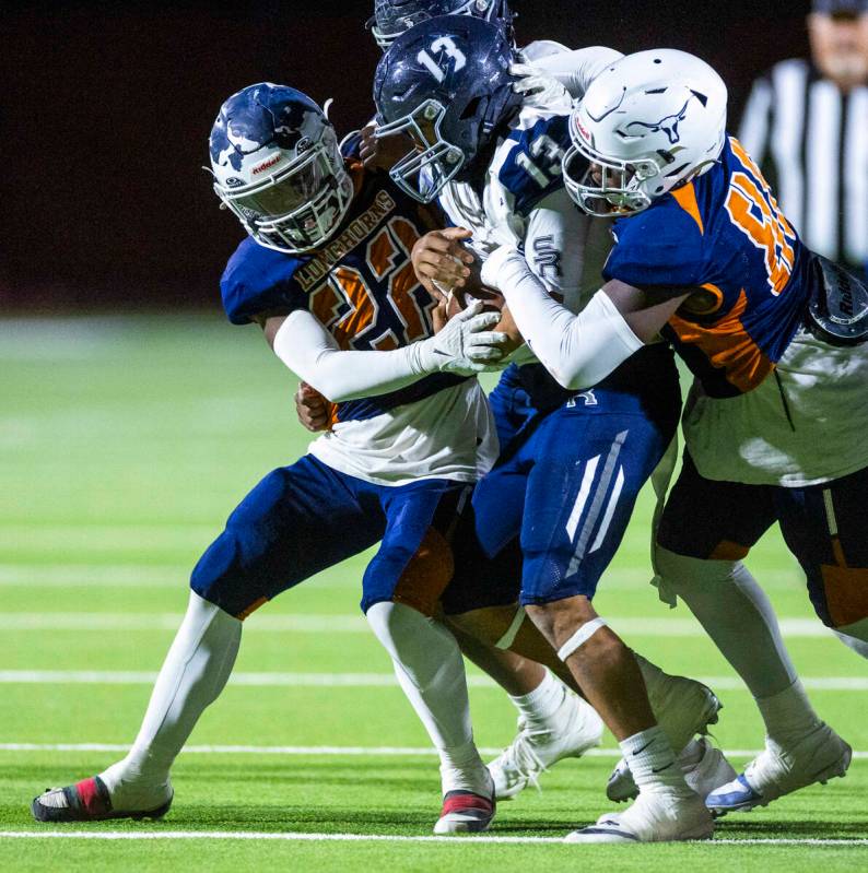 Shadow Ridge fullback Malahkai Berry (13) is wrapped up by Legacy middle linebacker Martell Mck ...