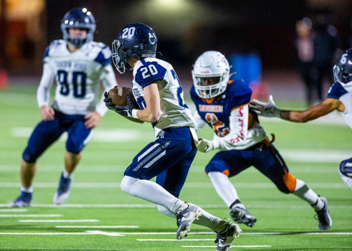 Shadow Ridge kickoff returner Hawkin Ledingham (20) evades Legacy defensive end Derric Marshall ...