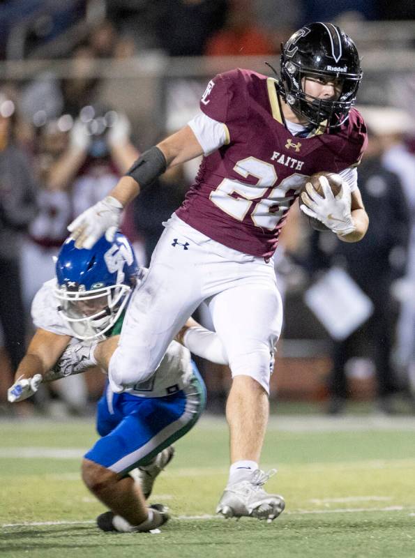 Faith Lutheran senior Nikolas Knight (26) avoids a tackle during the 5A Division II Southern Le ...