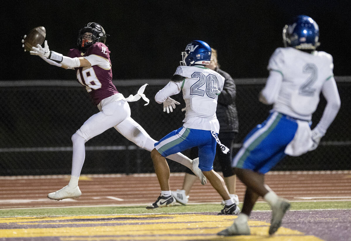 Faith Lutheran senior Jaxon Cope (18) catches a pass for a touchdown during the 5A Division II ...