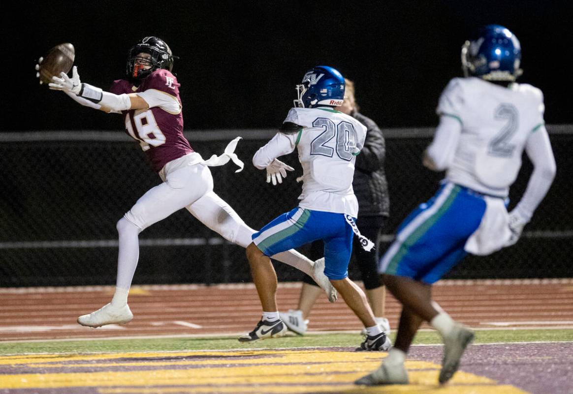 Faith Lutheran senior Jaxon Cope (18) catches a pass for a touchdown during the 5A Division II ...