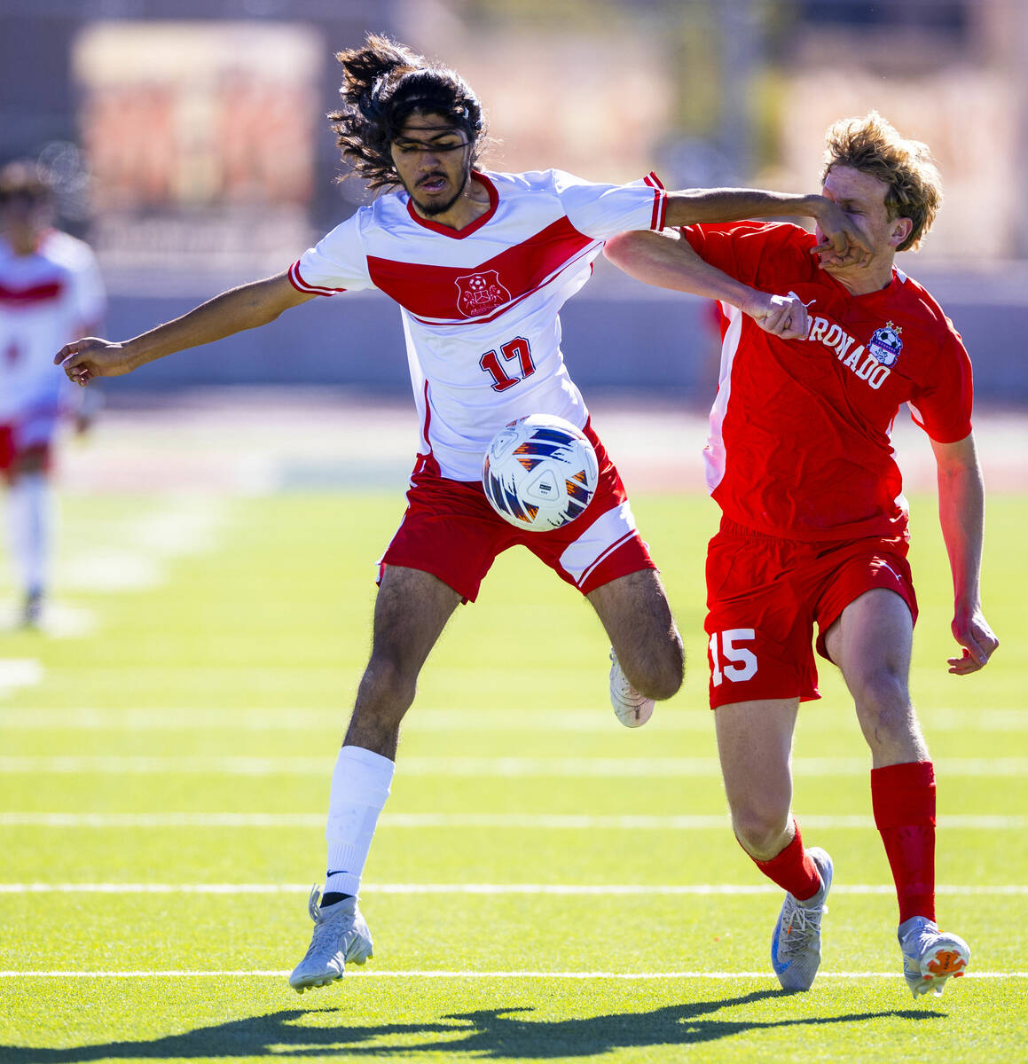 Wooster midfielder Luis Lopez Martinez (17) controls the ball while striking Coronado defender ...