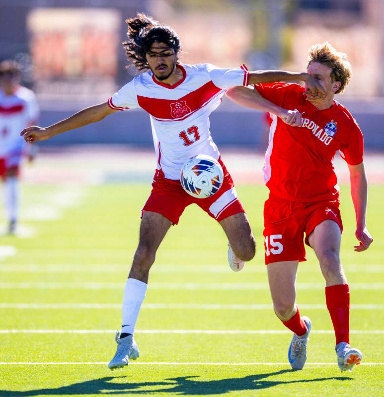 Wooster midfielder Luis Lopez Martinez (17) controls the ball while striking Coronado defender ...