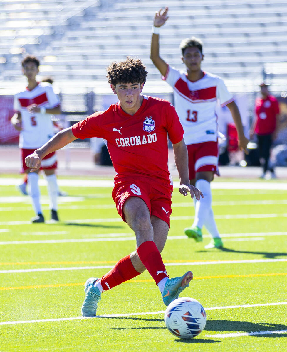 Coronado striker Dylan Flores (9) takes a shot on goal as Wooster Daemian Guzman (13) calls for ...