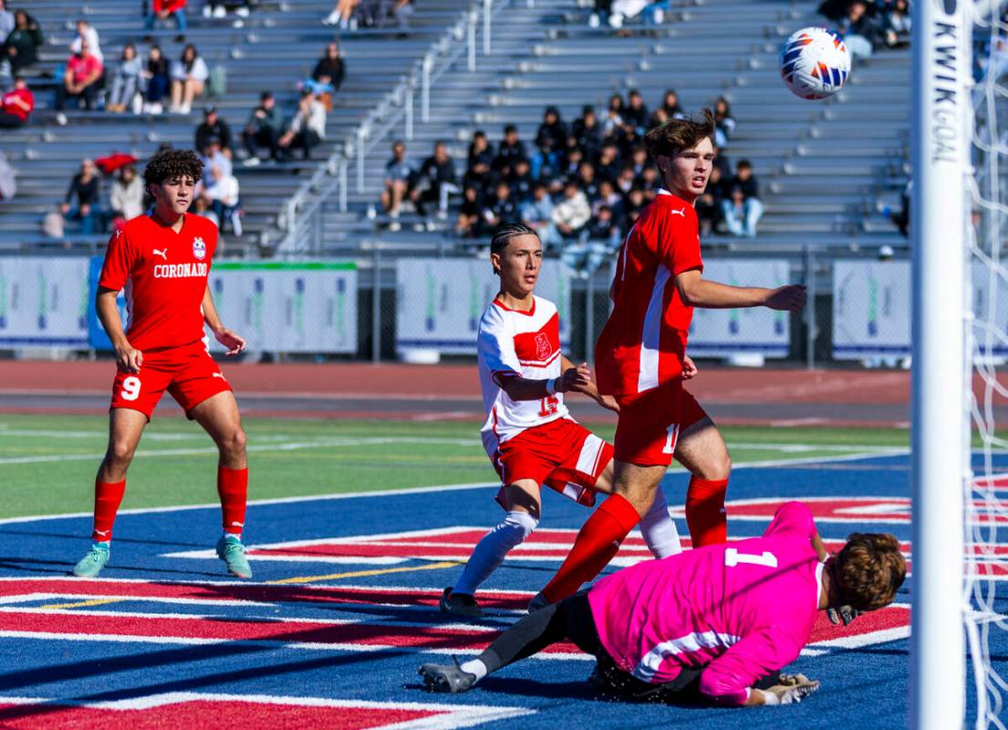 Coronado striker Gavin Flickinger (11) deflects the ball off his chest and past Wooster goalkee ...