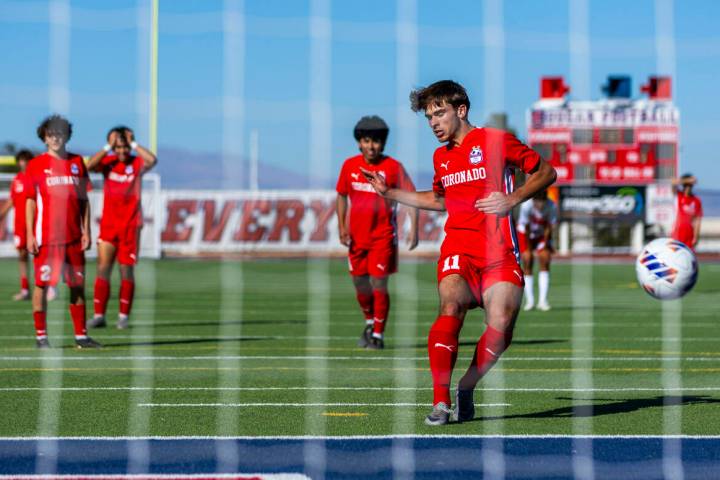 Coronado striker Gavin Flickinger (11) scores against Wooster on a penalty kick to set a state ...