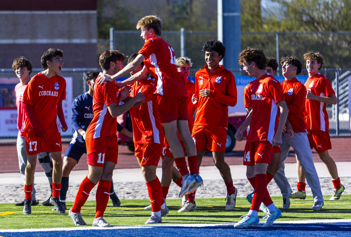 Coronado teammates celebrate a goal by striker Gavin Flickinger (11) against Wooster on a penal ...