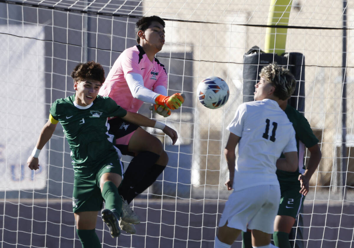 Hug High's goalie Diego Caceres and defender Jordan Gomez (3) defend against Palo Verde High's ...