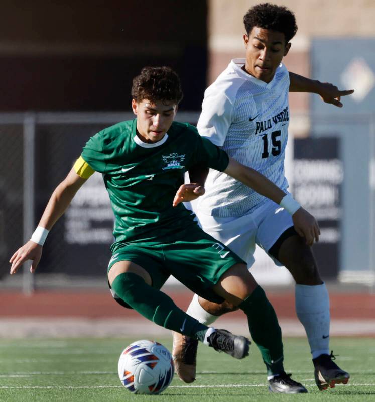 Hug High's defender Jordan Gomez (3) protects the ball from Palo Verde High's forward Trevon Ay ...