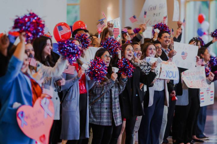 People line up to cheer for veterans during a Wall of Gratitude ceremony at the United Service ...