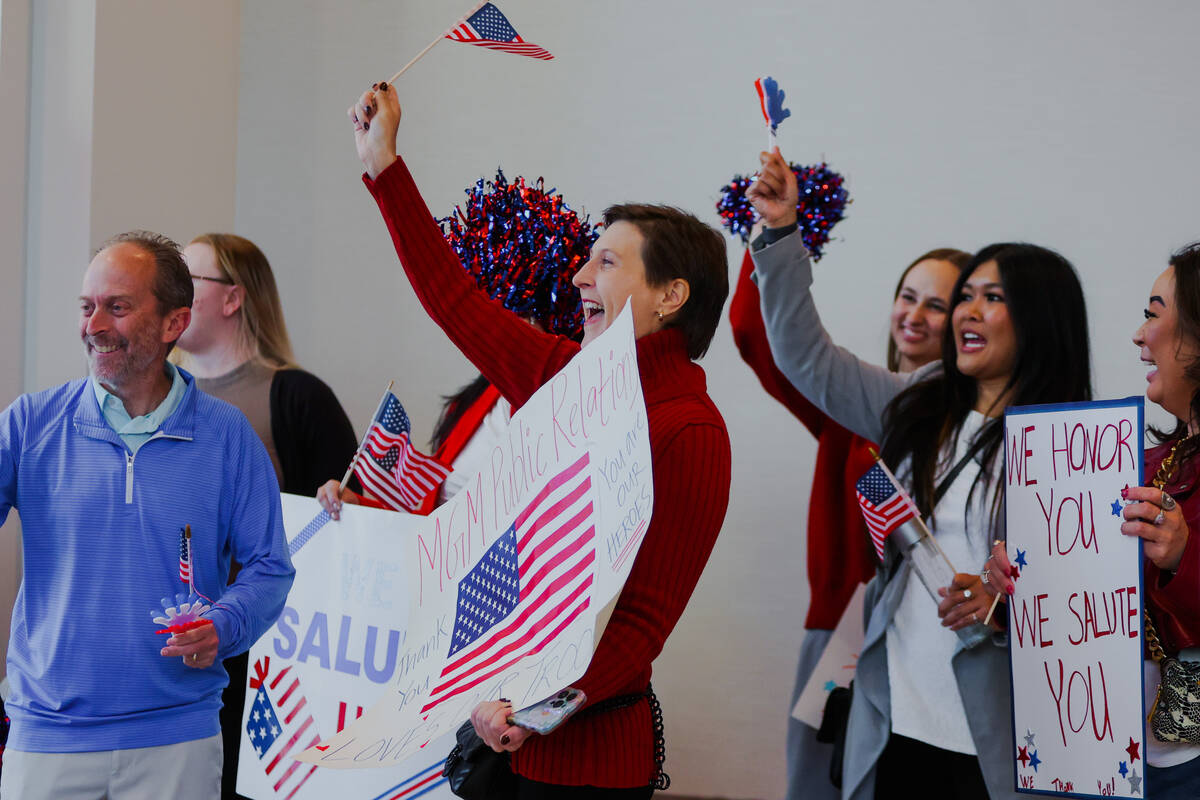 MGM employees cheer as wounded veterans make their way into a Wall of Gratitude ceremony during ...