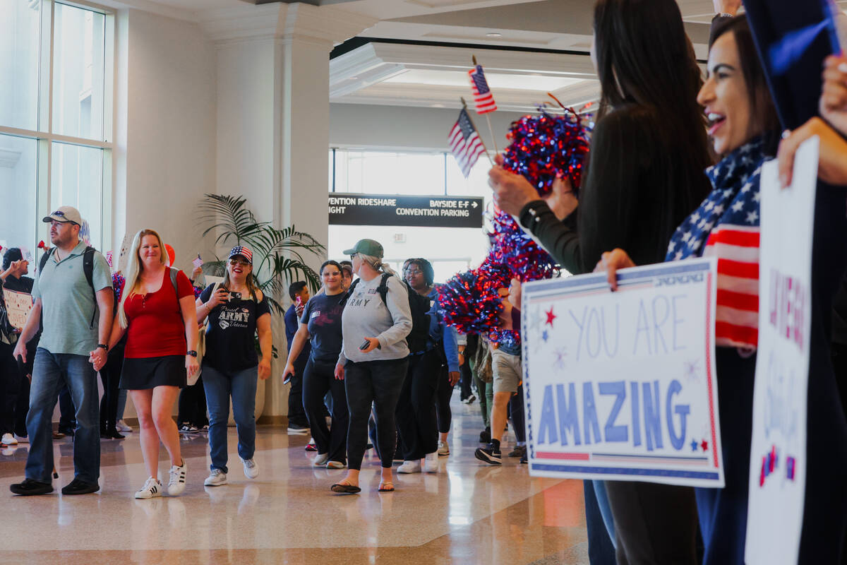 People line up to cheer for veterans and their families during a Wall of Gratitude ceremony at ...