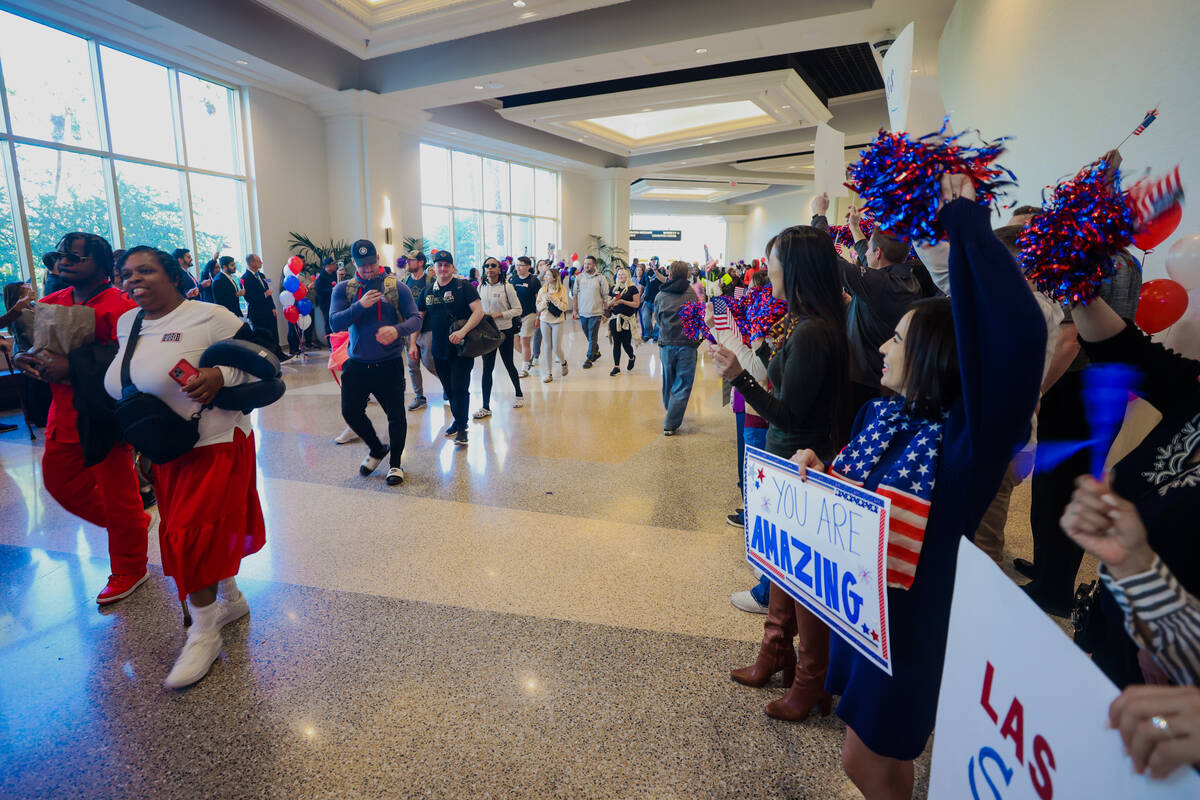 People line up to cheer for veterans and their families during a Wall of Gratitude ceremony at ...