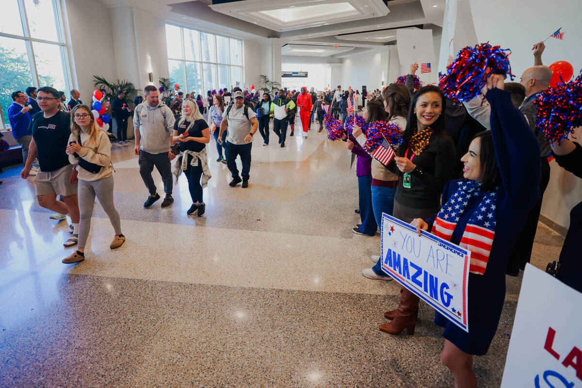 People line up to cheer for veterans and their families during a Wall of Gratitude ceremony at ...