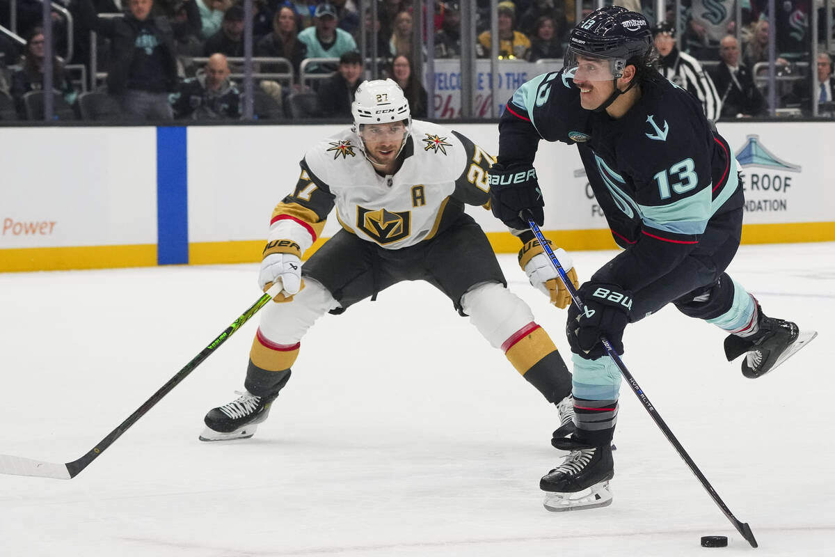 Seattle Kraken left wing Brandon Tanev (13) shoots and scores as Vegas Golden Knights defensema ...