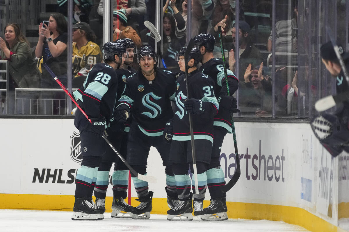 Seattle Kraken left wing Brandon Tanev, center facing, celebrates his goal against the Vegas Go ...