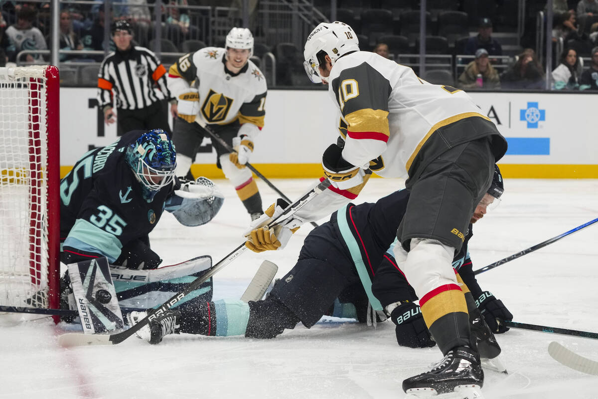 Seattle Kraken goaltender Joey Daccord (35) makes a save against Vegas Golden Knights center Ni ...