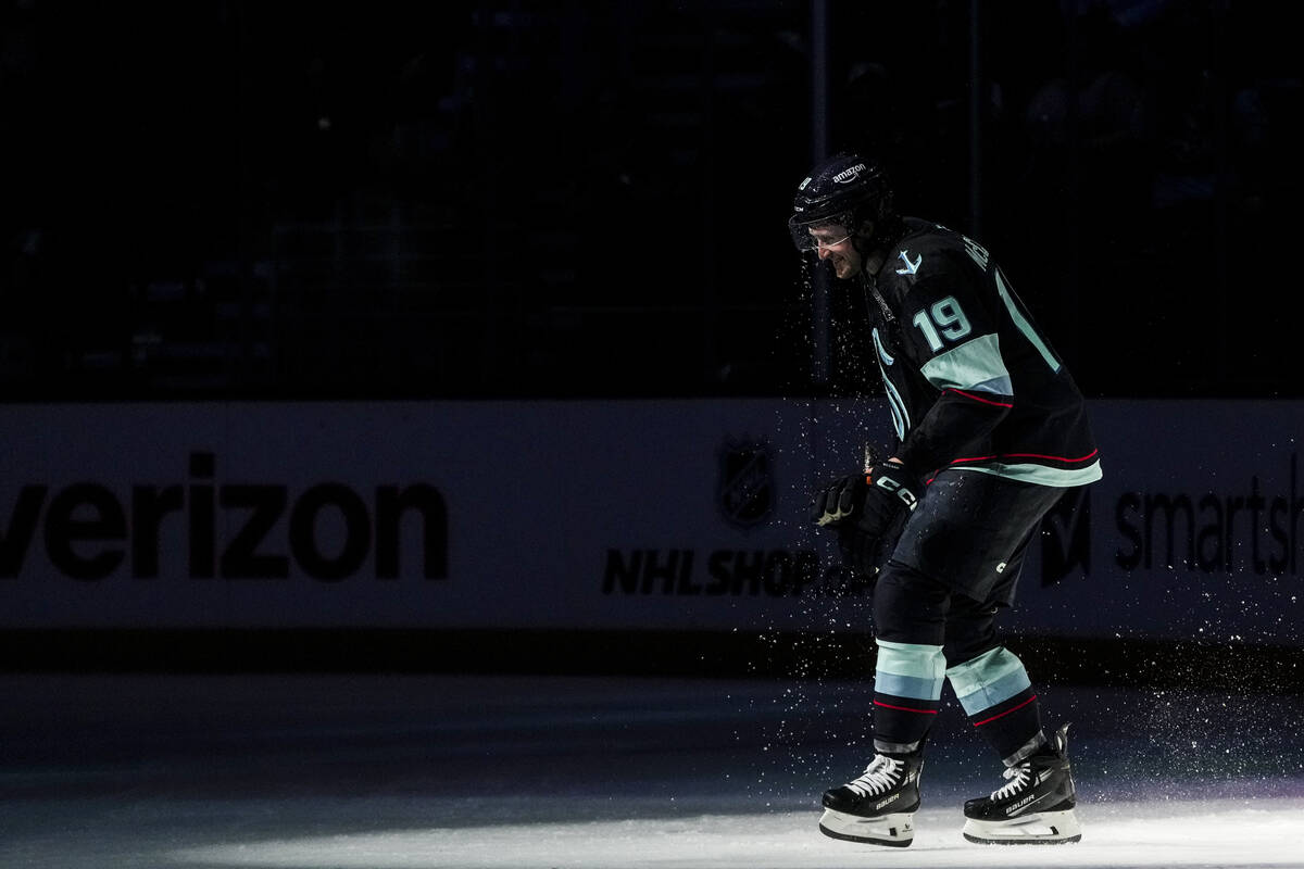 Seattle Kraken left wing Jared McCann smiles after being doused by teammates to celebrate his g ...