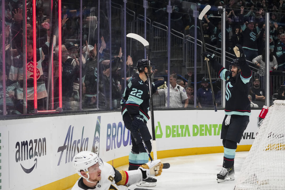 Seattle Kraken right wing Oliver Bjorkstrand (22) celebrates his goal with Chandler Stephenson, ...