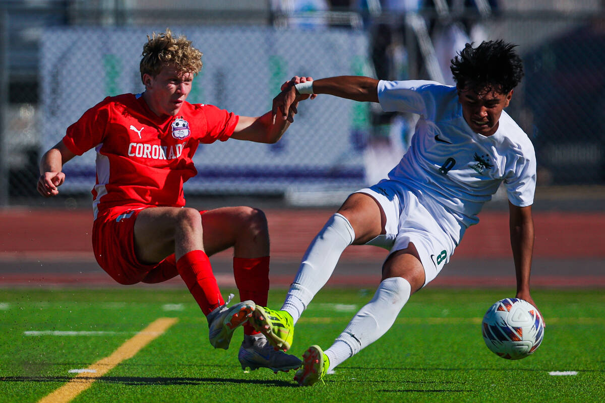 Coronado’s Maddox Findlay (16) and Hug midfielder Jordan Talavera (8) lose their balance ...