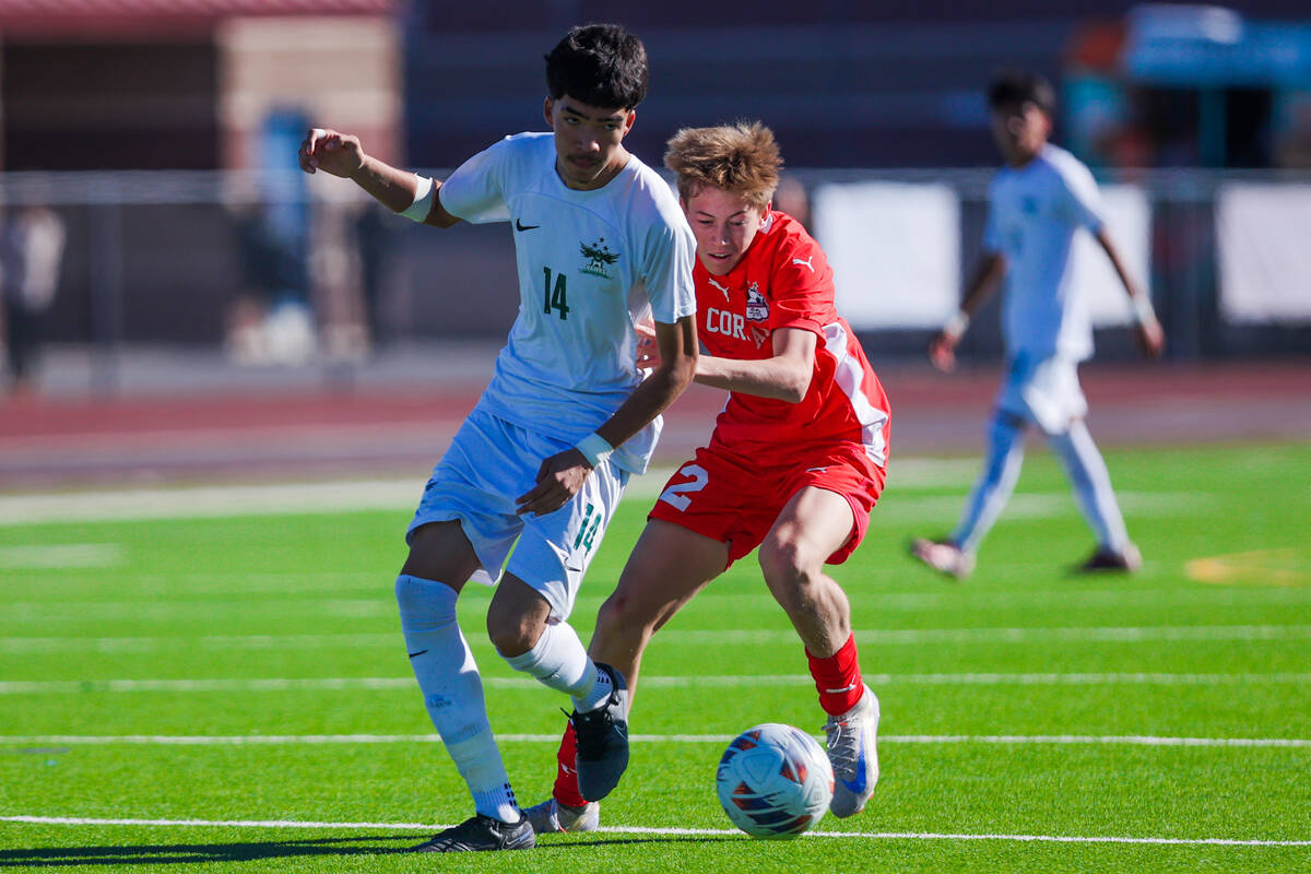 Coronado defender Brody Breeden (2) forces himself past Hug defender Christopher Avina (14) for ...