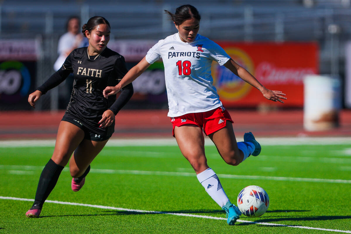 Faith Lutheran midfielder Ana Coe (11) closes in as Liberty midfielder Kaimiinameapono Wills (c ...