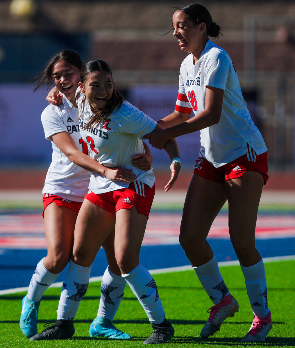 Liberty teammates celebrate a goal during a 5A girls soccer state championship match between Fa ...