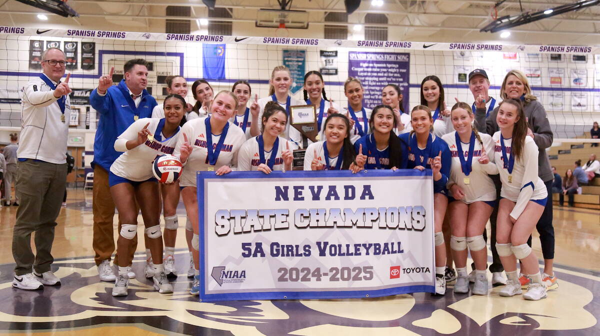 The Bishop Gorman volleyball team poses with the Class 5A state championship banner after defea ...