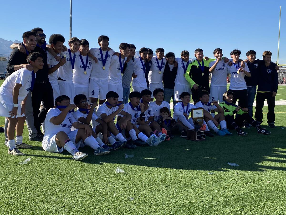 The Canyon Springs boys soccer team poses with its trophy after winning the Class 4A state cham ...