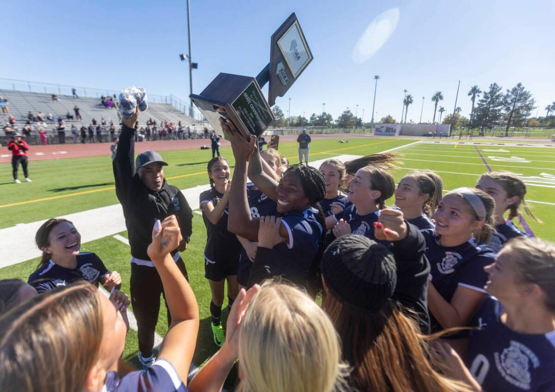 Centennial defender Natalie Penniston-John (11) holds up the trophy after winning the 4A girls ...