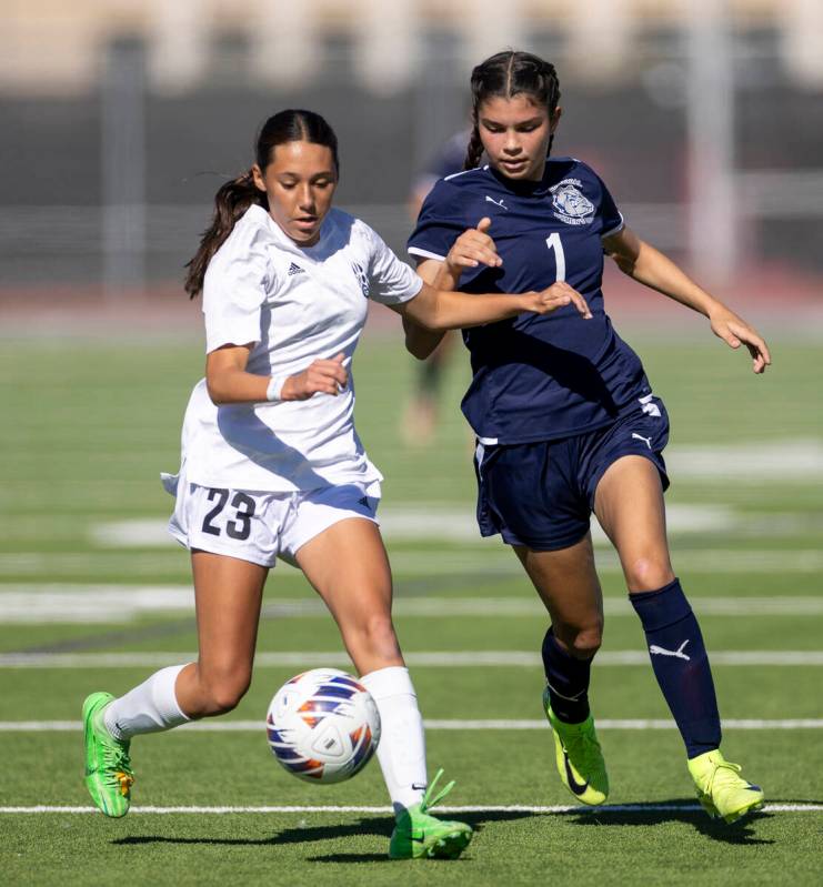 Galena freshman Gabriela Oberg (23) and Centennial freshman Alayna Malloy (1) compete for the b ...