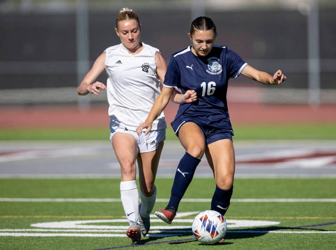 Galena senior Shelby Holback, left, and Centennial midfielder Julianne Donnelly (16) compete fo ...