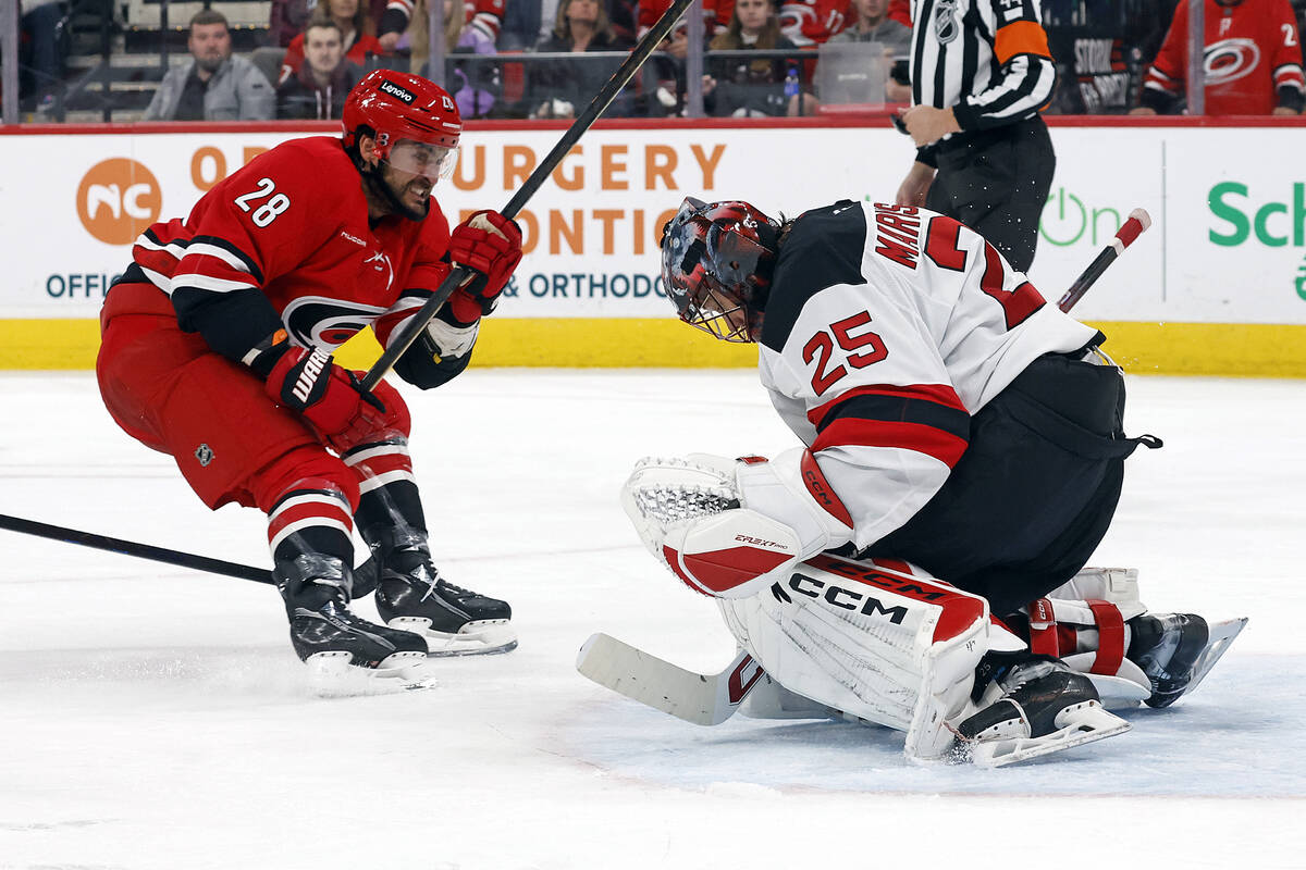 Carolina Hurricanes' William Carrier (28) has his shot swallowed by New Jersey Devils goaltende ...