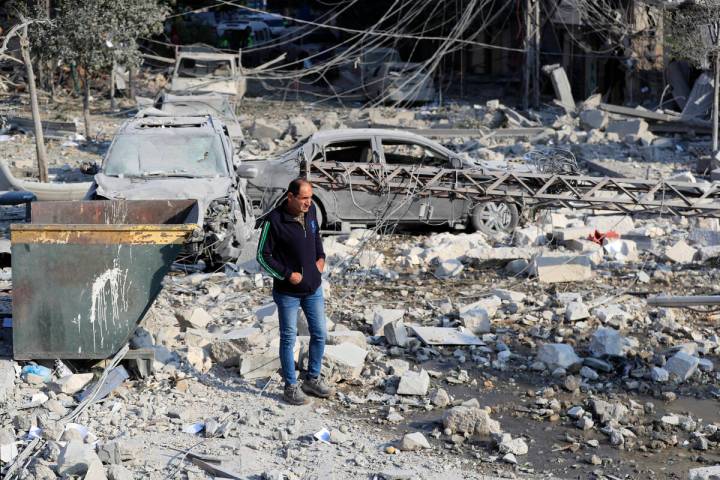 A resident checks the site of an Israeli airstrike in Tyre, southern Lebanon, Saturday, Nov. 9, ...