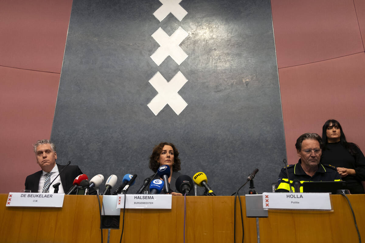 Amsterdam's Mayor Femke Halsema, centre, acting Amsterdam police chief Peter Holla, left, and h ...