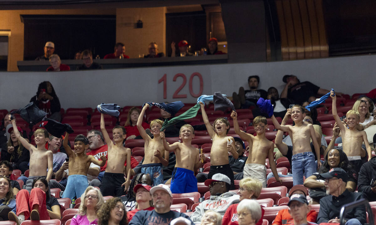 A group of young fans cheer for UNLV during the college basketball game against the Memphis Tig ...