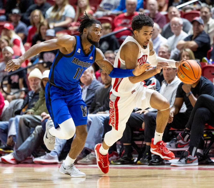 UNLV guard Jailen Bedford (14) keeps the ball from Memphis Tigers guard Tyrese Hunter (11) duri ...