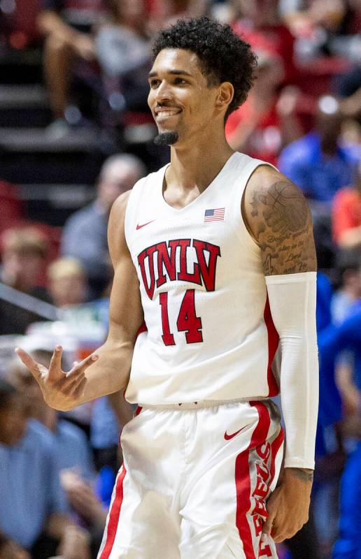 UNLV guard Jailen Bedford (14) holds up 3 fingers after scoring a basket during the college bas ...