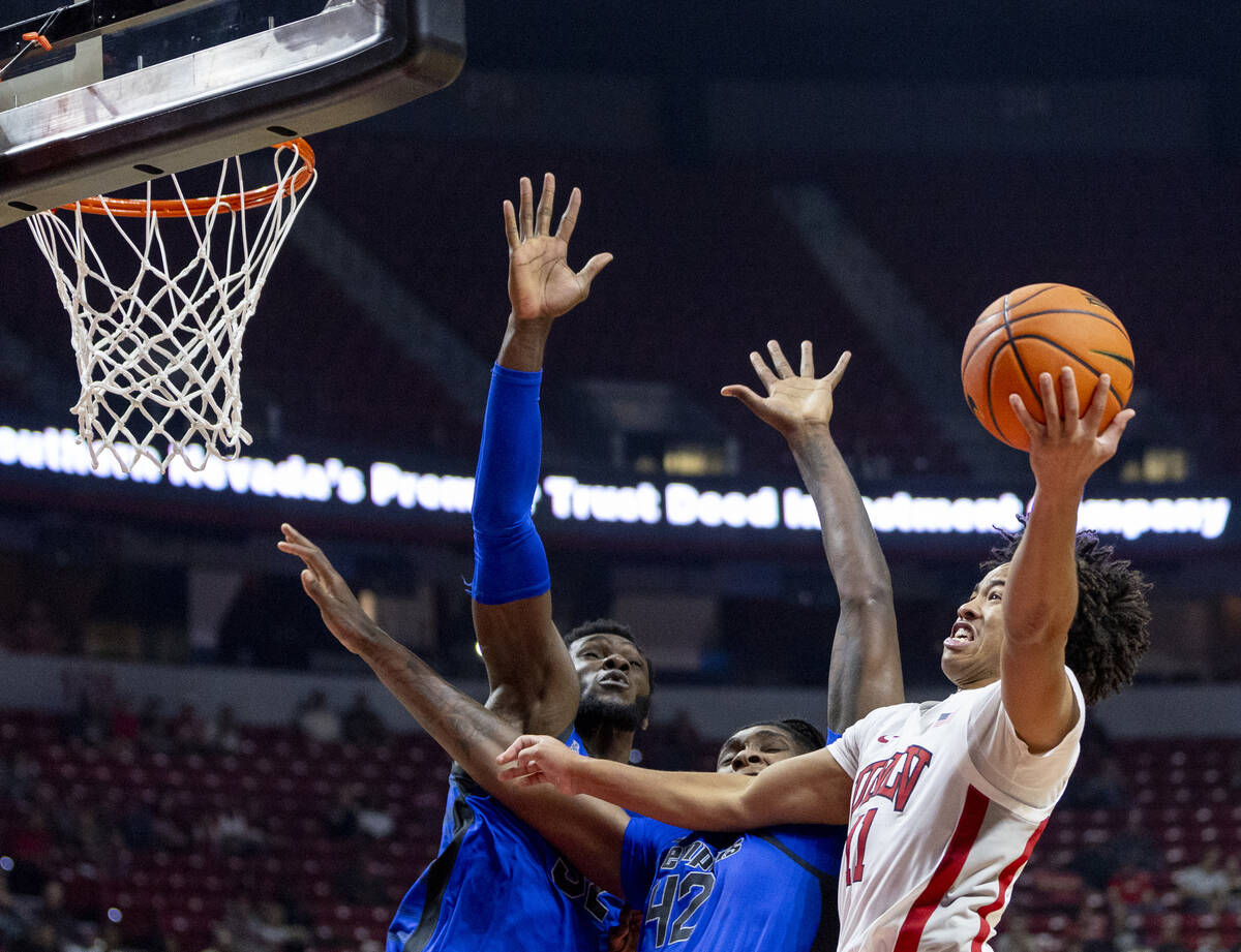 UNLV guard Dedan Thomas Jr. (11) attempts to get to the hoop during the college basketball game ...