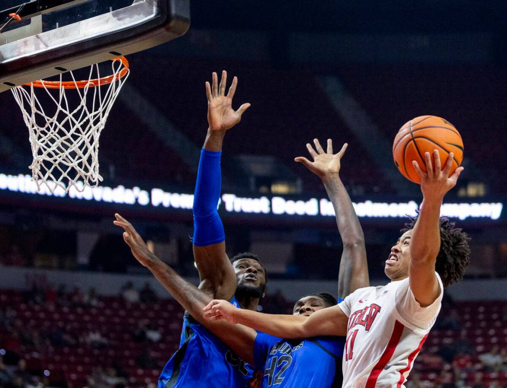 UNLV guard Dedan Thomas Jr. (11) attempts to get to the hoop during the college basketball game ...