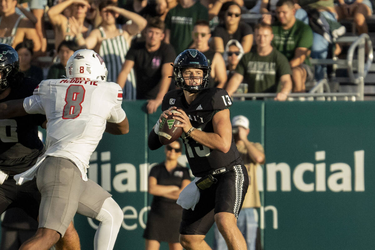 Hawaii quarterback Brayden Schager (13) looks to throw the ball during the first half of an NCA ...