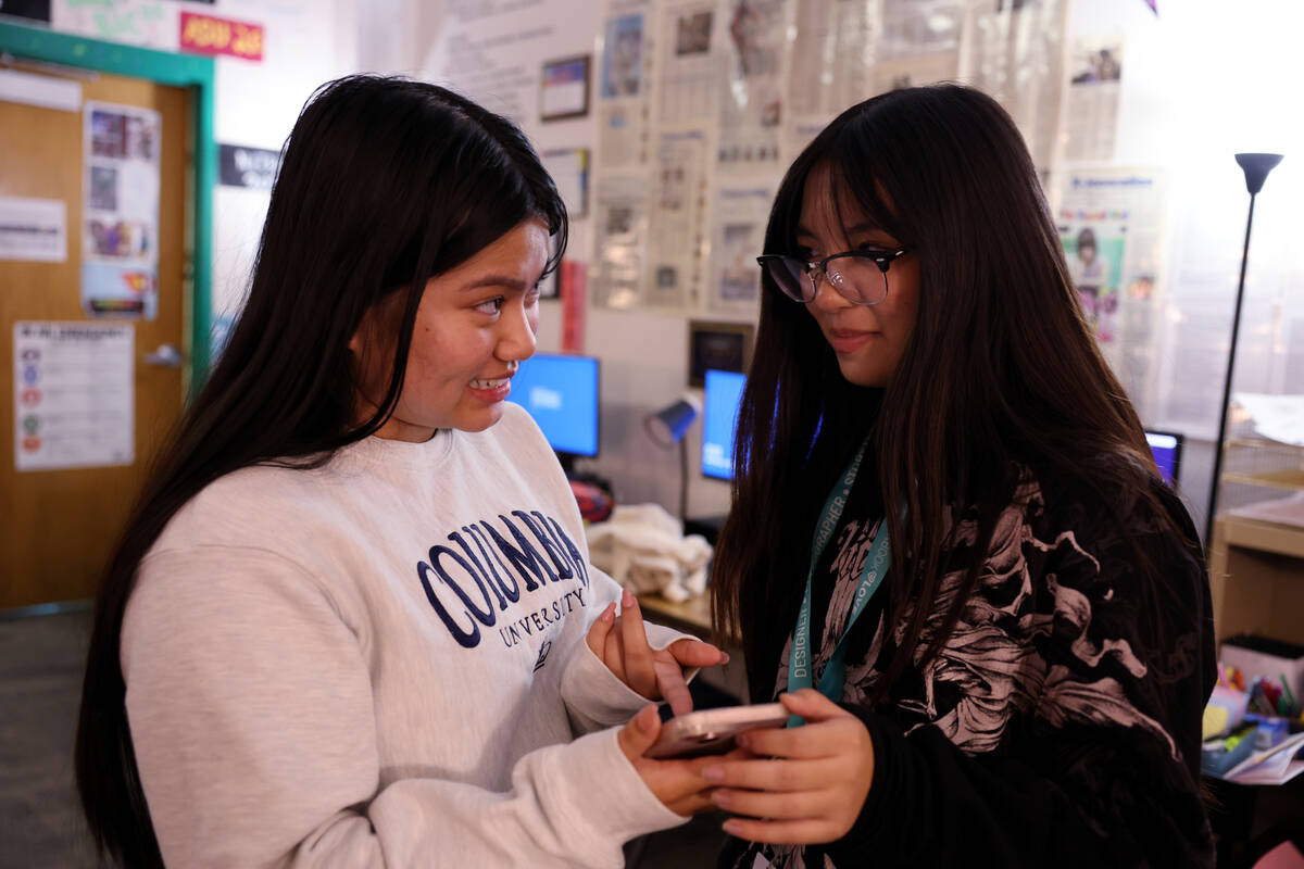 The InvestiGator Photo Editor Angelina Santos, left, works with Janelle Mercado at the Henderso ...