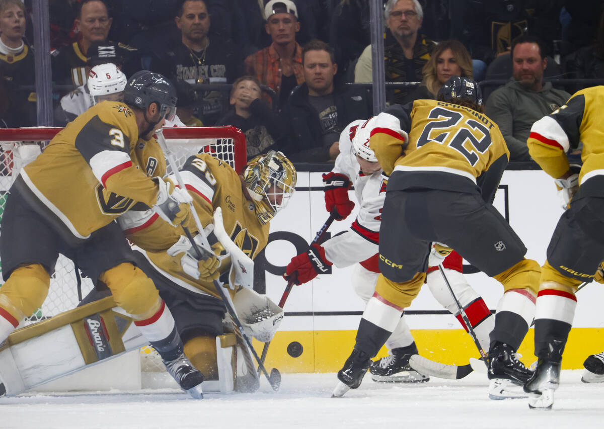 Golden Knights defenseman Brayden McNabb (3) and goaltender Adin Hill (33) defend the net as Ca ...