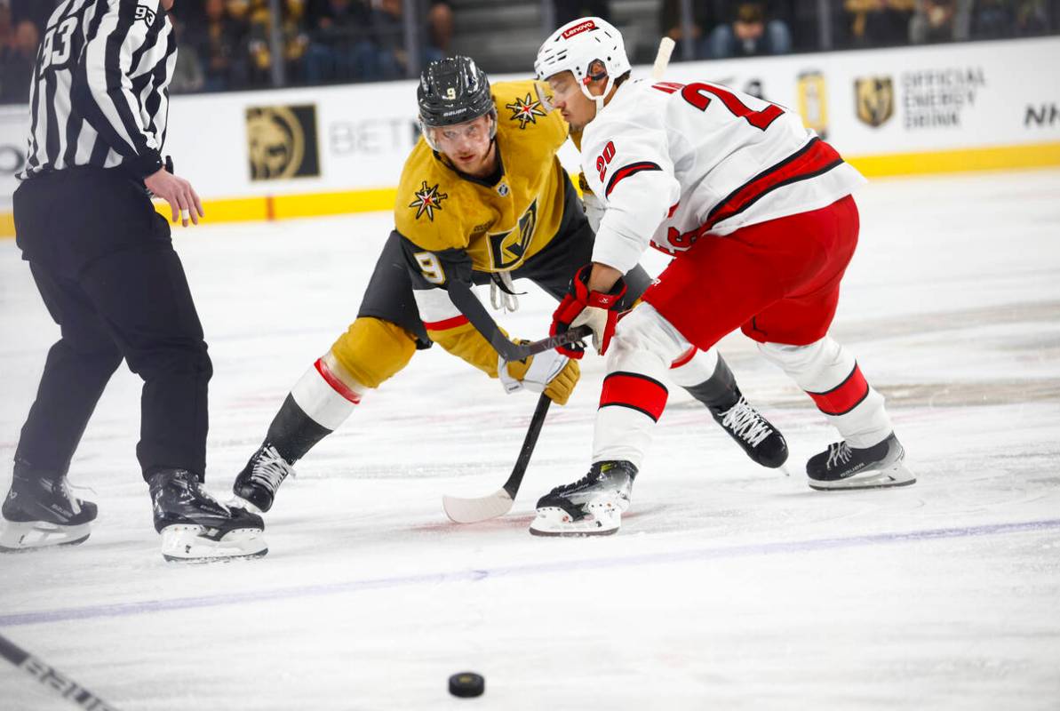 Golden Knights center Jack Eichel (9) passes the puck under pressure from Carolina Hurricanes c ...