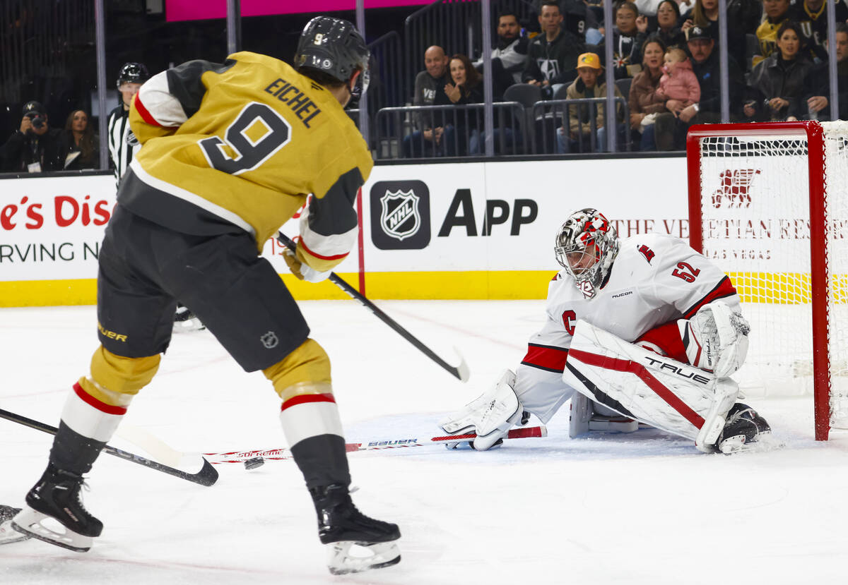 Carolina Hurricanes goaltender Pyotr Kochetkov (52) blocks a pass in front of the net from Gold ...