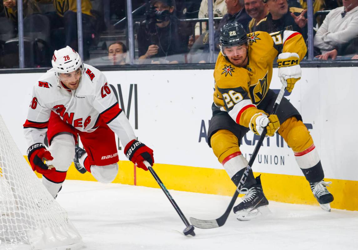 Golden Knights right wing Alexander Holtz (26) vies for the puck against Carolina Hurricanes de ...